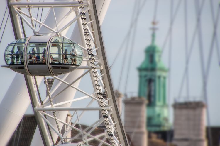A pod of the London Eye wheel with buildings in the background
